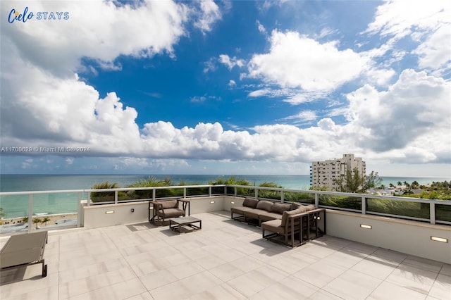 view of patio / terrace with an outdoor living space, a balcony, and a water view