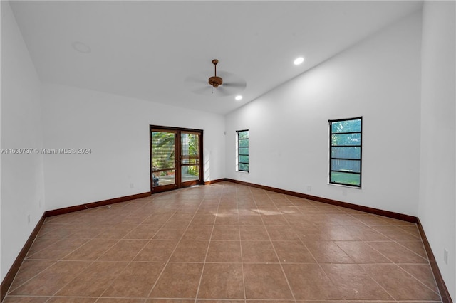 unfurnished room featuring ceiling fan, light tile patterned flooring, and lofted ceiling