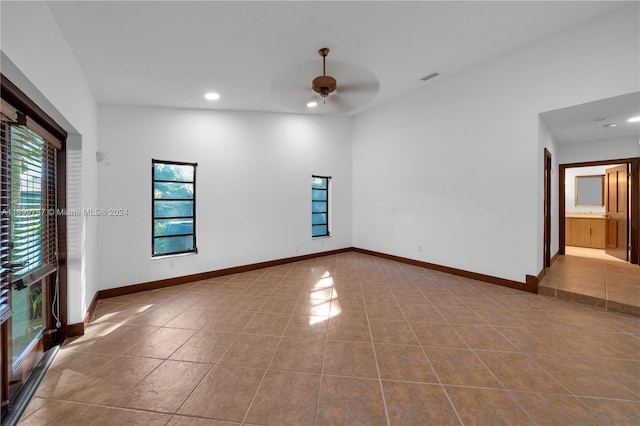 spare room featuring ceiling fan and light tile patterned flooring