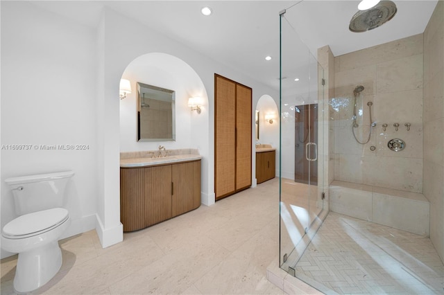 bathroom featuring vanity, toilet, and an enclosed shower