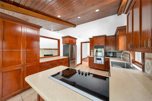 kitchen featuring sink, beamed ceiling, backsplash, light tile patterned floors, and black appliances