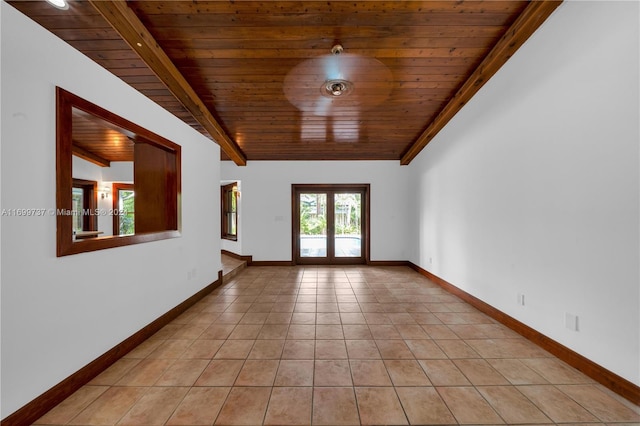 empty room with french doors, beamed ceiling, wooden ceiling, and light tile patterned floors