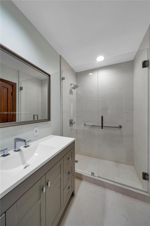 bathroom featuring vanity and an enclosed shower