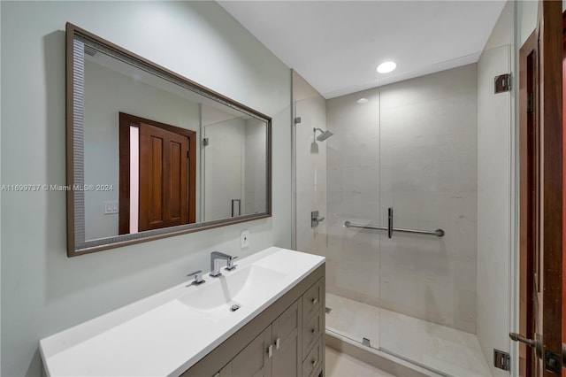 bathroom with vanity and a shower with shower door