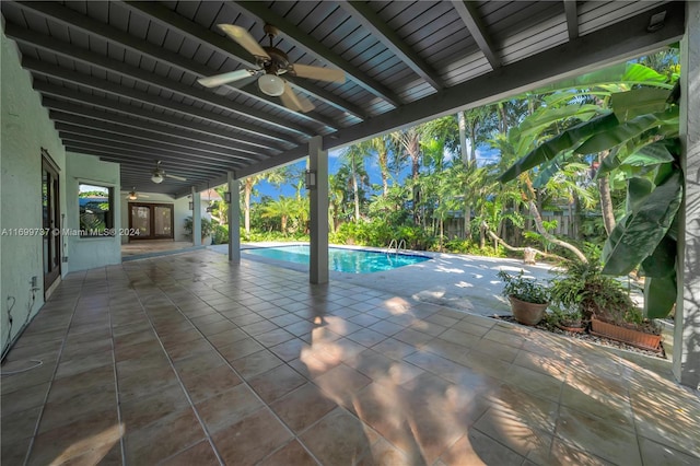 view of swimming pool featuring ceiling fan and a patio