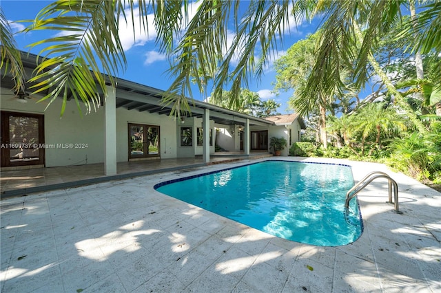 view of pool featuring french doors and a patio area