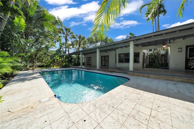 view of pool with ceiling fan and a patio