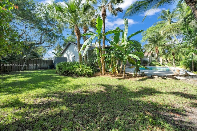 view of yard with a fenced in pool