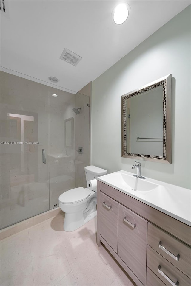 bathroom with walk in shower, tile patterned floors, vanity, and toilet