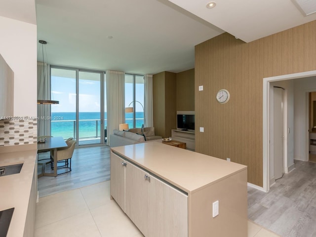 kitchen featuring a center island, expansive windows, and light hardwood / wood-style floors