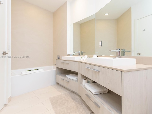 bathroom with tile patterned floors, a washtub, and vanity