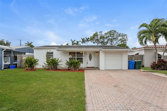 view of front of property with a front lawn and a garage