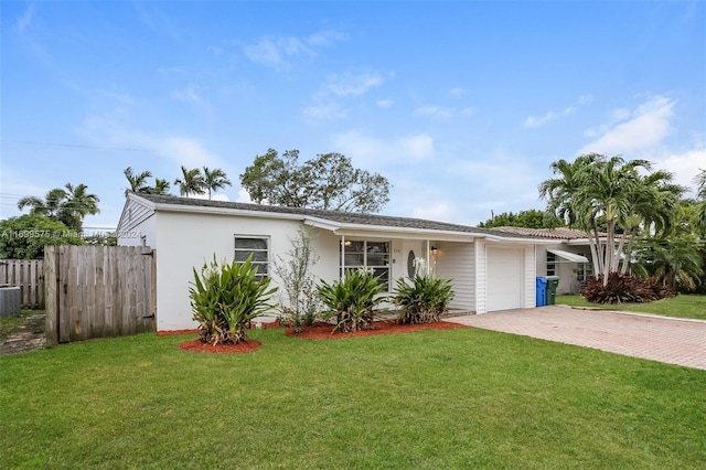 single story home featuring central AC, a front lawn, and a garage