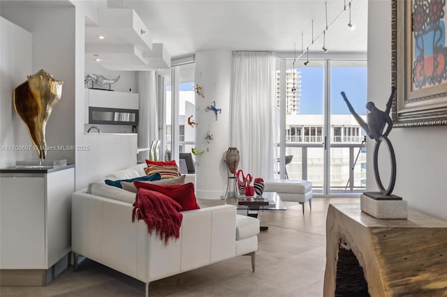 living room featuring floor to ceiling windows and a healthy amount of sunlight