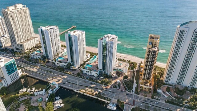 bird's eye view with a water view and a beach view