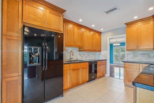 kitchen with black appliances, sink, decorative backsplash, light tile patterned floors, and a notable chandelier