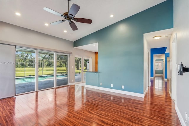 unfurnished living room featuring hardwood / wood-style flooring, ceiling fan, and lofted ceiling