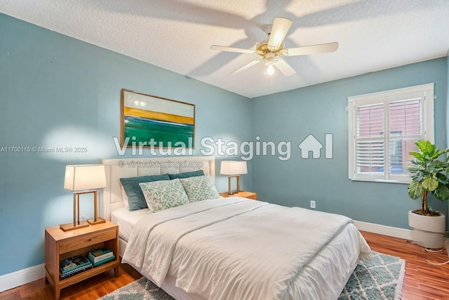 bedroom featuring hardwood / wood-style floors, a textured ceiling, and ceiling fan