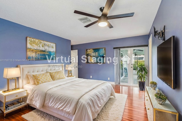 bedroom featuring wood-type flooring, a textured ceiling, access to outside, and ceiling fan