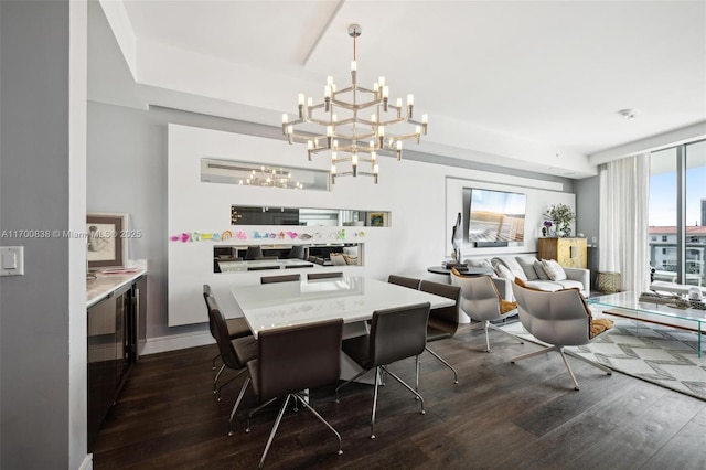 dining area with a chandelier and dark hardwood / wood-style flooring