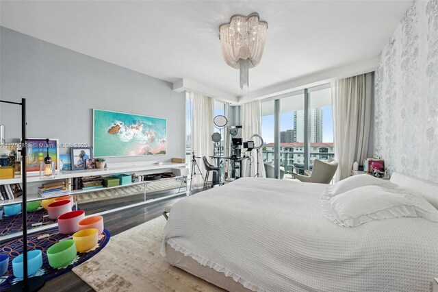 bedroom with hardwood / wood-style flooring and a chandelier