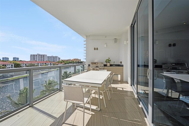 balcony featuring a water view and grilling area