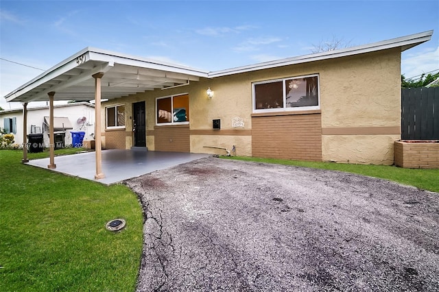 exterior space featuring a carport and a yard