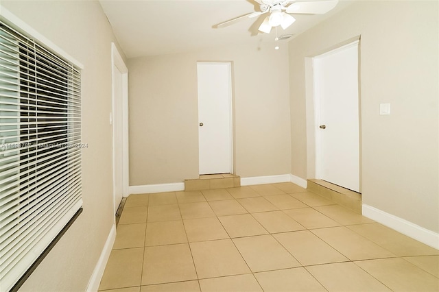 spare room featuring light tile patterned floors and ceiling fan