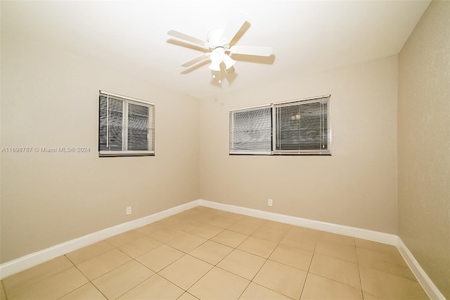 tiled empty room with ceiling fan