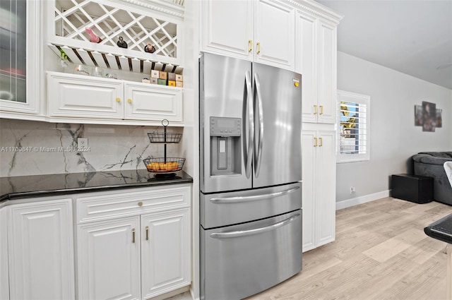 kitchen featuring white cabinets, stainless steel refrigerator with ice dispenser, backsplash, and light hardwood / wood-style flooring