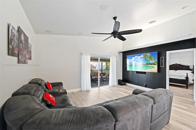 living room with ceiling fan, light wood-type flooring, and vaulted ceiling