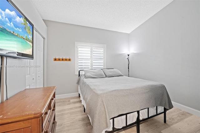 1226 SW 46th Ave, Deerfield Beach, FL 33442 - bedroom featuring light wood-style floors, baseboards, and a textured ceiling