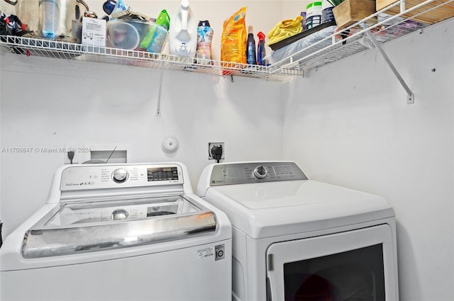 clothes washing area featuring separate washer and dryer