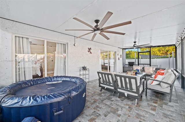 view of patio with outdoor lounge area and a hot tub