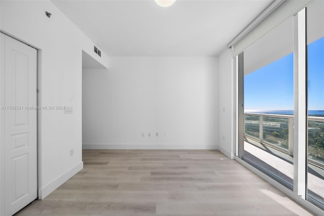 interior space with access to exterior, a closet, and light wood-type flooring