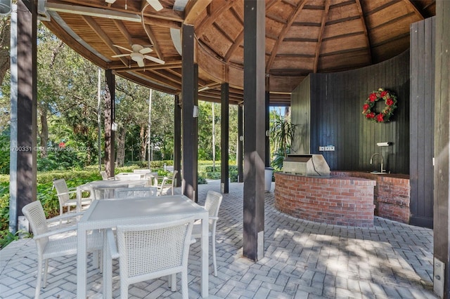 view of patio with an outdoor kitchen and ceiling fan