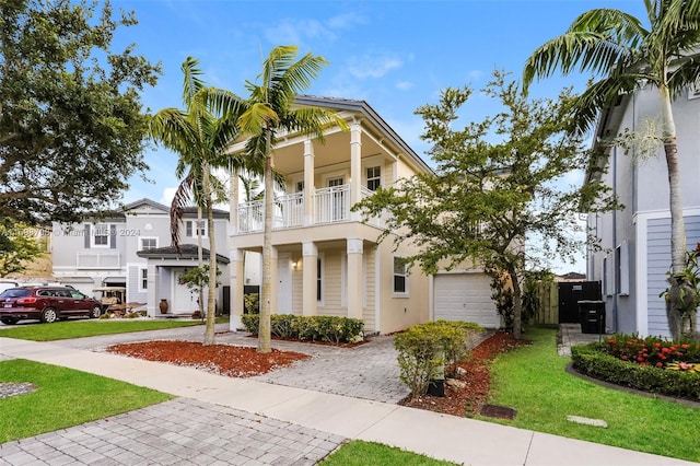 view of front facade featuring a balcony and a front yard