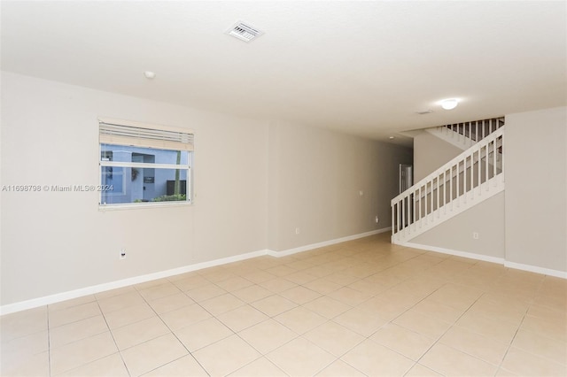 unfurnished room featuring light tile patterned floors