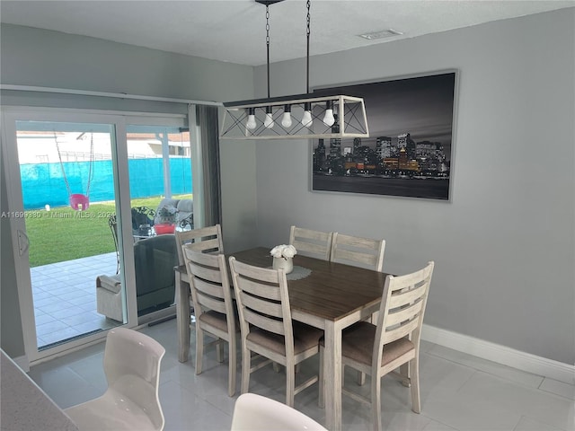 dining space with tile patterned flooring