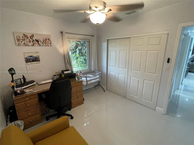 office space with ceiling fan and light tile patterned floors