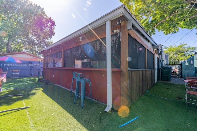 view of property exterior featuring a yard and exterior bar