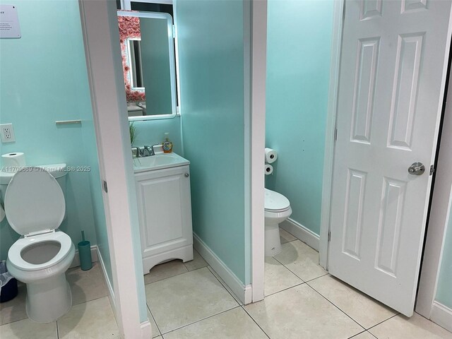 bathroom with vanity, tile patterned floors, and toilet