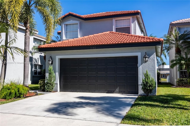 mediterranean / spanish home featuring a front yard and a garage