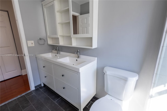 bathroom featuring hardwood / wood-style floors, vanity, and toilet