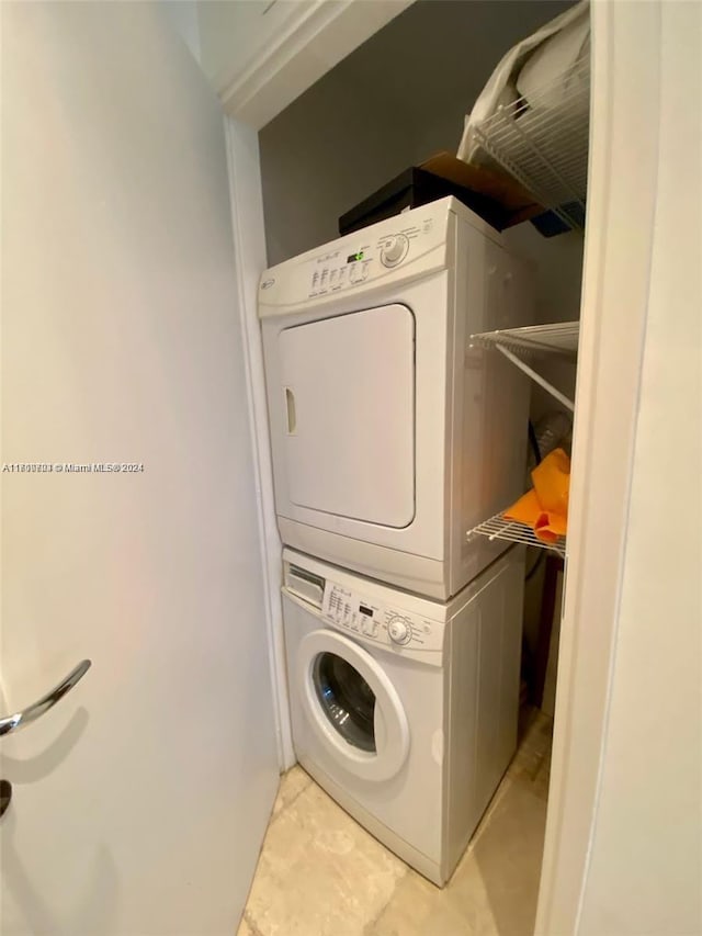 washroom featuring stacked washer and dryer