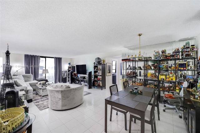 dining area featuring plenty of natural light, a textured ceiling, and light tile patterned floors