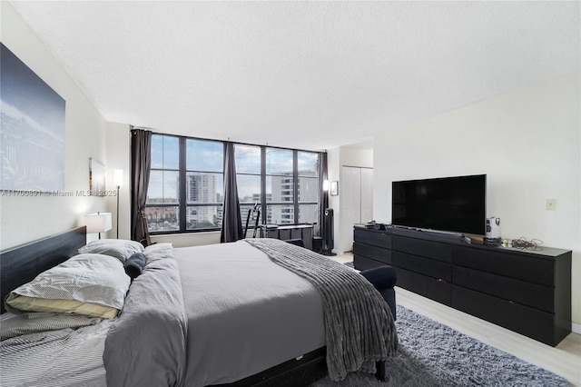 bedroom featuring light wood finished floors and a closet