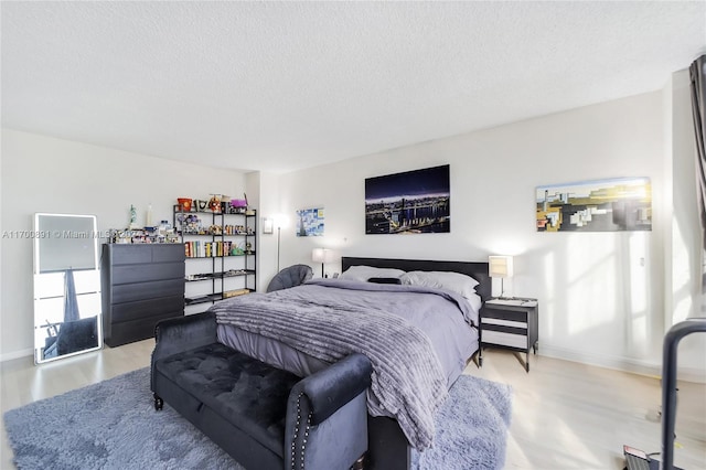 bedroom with wood-type flooring and a textured ceiling