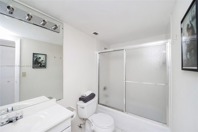 full bathroom featuring toilet, enclosed tub / shower combo, visible vents, and vanity