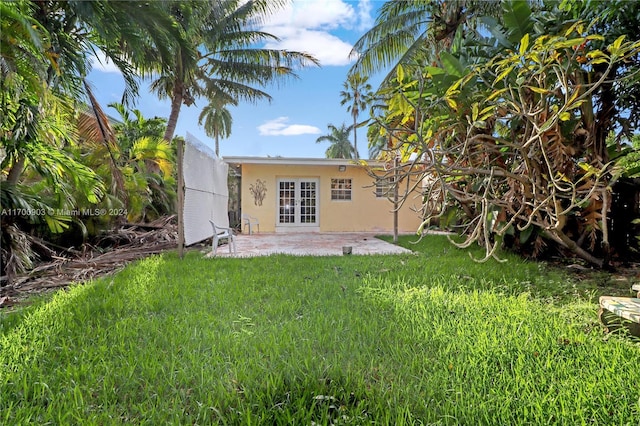 back of house with a lawn, french doors, and a patio